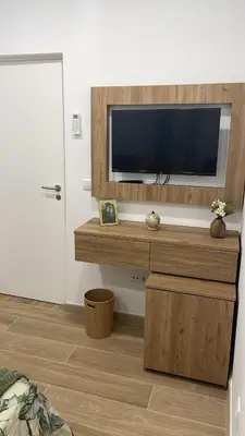 a living room with a flat screen tv on a wall at Casa Tapada do Bento II- Albufeira in Albufeira