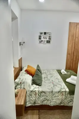 a bedroom with a bed with pillows on it at Casa Tapada do Bento II- Albufeira in Albufeira