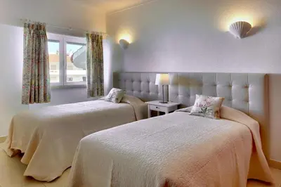 a bedroom with two beds and a window at Atlantic Horizon by Seareen in Albufeira