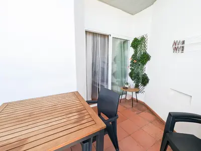 a dining room with a table and a chair at Sunset in Albufeira