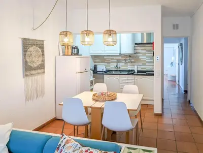 a kitchen and dining room with a table and chairs at Sunset in Albufeira