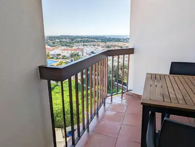 a balcony with a table and a view of the city at Sunset in Albufeira