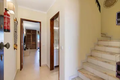a hallway with stairs in a house at Apartamento Perfeito in Albufeira