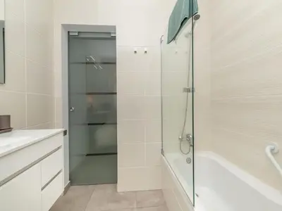 a shower with a glass door in a bathroom at Akisol Albufeira Gentle in Albufeira