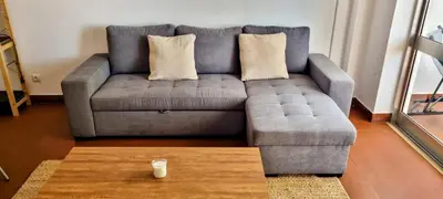 a grey couch with pillows and a coffee table in a living room at Appartement Touristique dans une résidence Hôtelière Silchoro in Albufeira