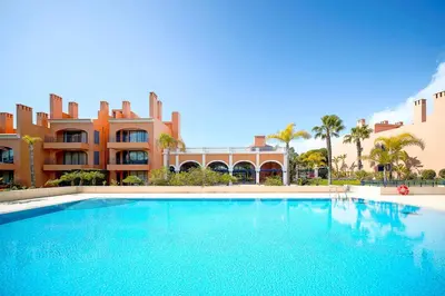 a large swimming pool in front of a building at Vila Sol F5 W Golf and Pool Apartment in Vilamoura