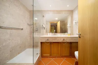 a bathroom with a shower and a sink and a toilet at Vila Sol F5 W Golf and Pool Apartment in Vilamoura