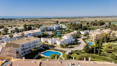 an aerial view of a resort with a swimming pool at Greice Homes - T2 - JV - Vilamoura Centre in Quarteira