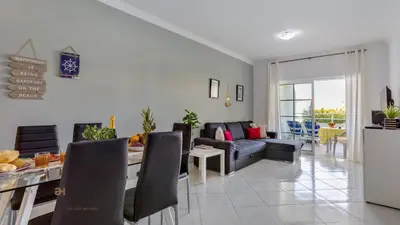 a living room with a couch and a table at Greice Homes - T2 - JV - Vilamoura Centre in Quarteira