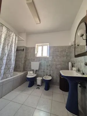 a bathroom with a sink and a toilet and a tub at Costa Mar by Albufeira Rental in Olhos de Água
