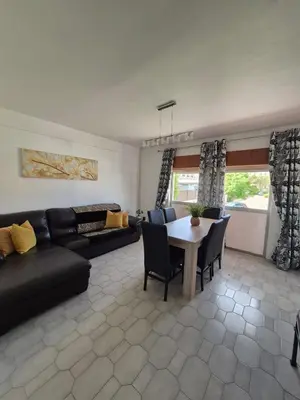 a living room with a couch and a table at Costa Mar by Albufeira Rental in Olhos de Água