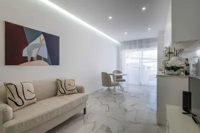 a living room with a couch and a table at Baleeira Sea View Studio in Albufeira