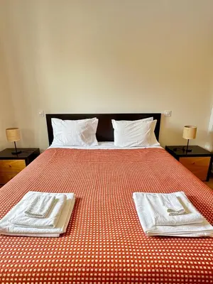 a bed with two towels on top of it at Casa Vista Brejos in Albufeira