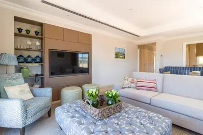 a living room with a couch and a table at Dunas Douradas Beach Club in Vale do Lobo