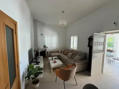 a living room with a couch and a table at Maison entière 10-12 personnes à Goldra de çima Loulé in Loulé