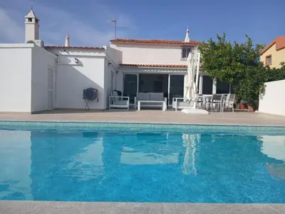 a villa with a swimming pool and a house at Maison entière 10-12 personnes à Goldra de çima Loulé in Loulé