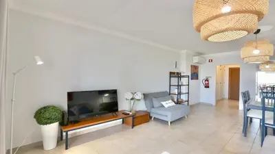 a living room with a large flat screen tv at Mediterraneo 2ºB - CD 318, Cleverdetails - sleeps 2 adults and 1 child in Vilamoura