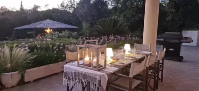 a table with candles and a piano in a garden at Casa Amani in Loulé