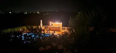 a house with a light on it at night at Casa Amani in Loulé