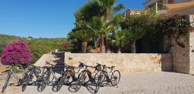 a group of bikes parked next to a stone wall at Casa Amani in Loulé