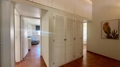 a hallway with white closets in a apartment at Tropicana by Check-in Portugal in Albufeira