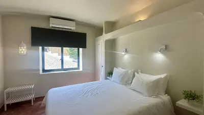 a bedroom with a white bed with a window at Tropicana by Check-in Portugal in Albufeira