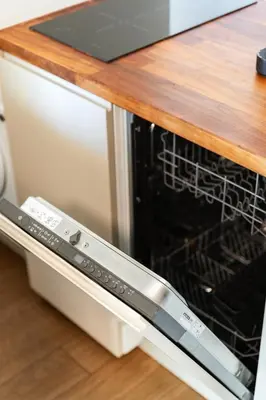 a dishwasher with its door open in a kitchen at Gorgeous Flat 3min Walk to Beach in Albufeira