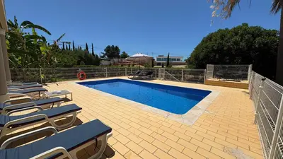 a bedroom with a bed and a sliding glass door at Atanasio by Check-in Portugal in Albufeira