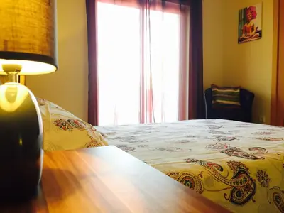 a bedroom with a bed and a lamp and a window at Albufeira Luxury Villa in Albufeira