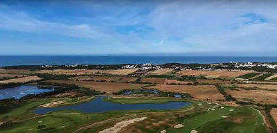 an aerial view of a golf course with the ocean at VILAMOURA - The Residences in Quarteira