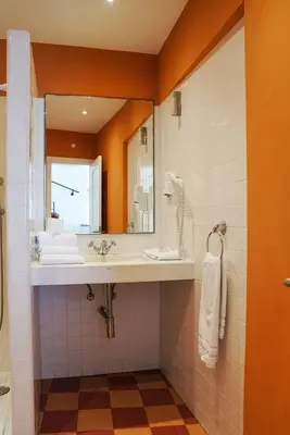 a bathroom with a sink and a mirror at Breathtaking BeachFront House in Albufeira