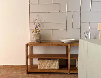 a wooden console table with a vase on it at Vila Antic in Almancil