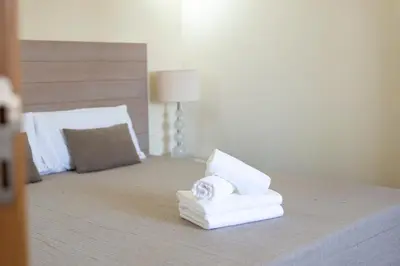 a pile of towels sitting on top of a bed at Casa Do Vale - Algarve in Vargem da Mão