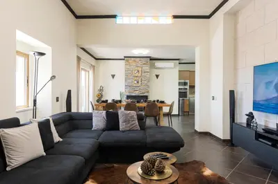 a living room with a couch and a table at Casa Do Vale - Algarve in Vargem da Mão