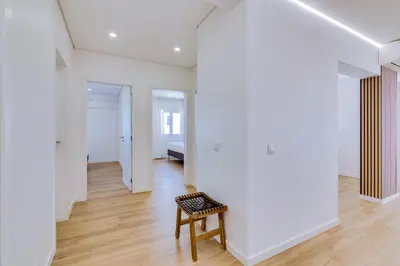 a room with white walls and a bench in the middle at Mar Azul 2 Bdr Apartment Quarteira in Quarteira