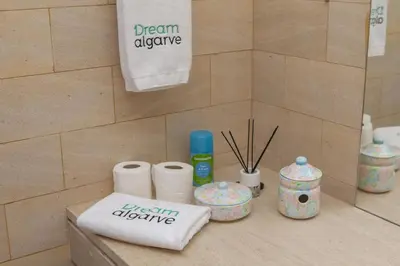a bathroom counter with toilet paper and a towel at A02 - Casa Topazio in Quarteira in Quarteira