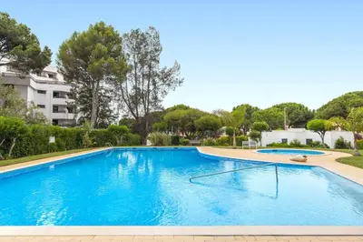 a large blue swimming pool in a building at A02 - Casa Topazio in Quarteira in Quarteira