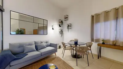 a living room with a couch and a table at Apartamento T0 MFA, 400m Praia dos Pescadores in Albufeira