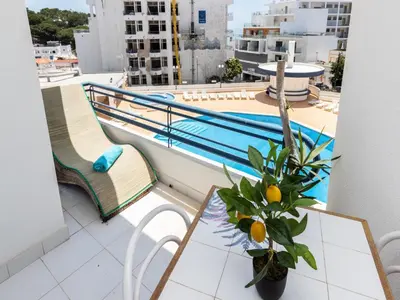 a balcony with a pool and a table and chairs at Akisol Albufeira Getaway in Olhos de Água