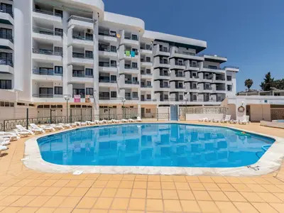 a large swimming pool in front of a hotel at Akisol Albufeira Getaway in Olhos de Água