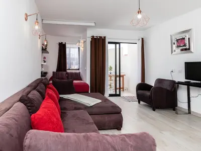 a living room with a large brown couch and chairs at Akisol Albufeira Getaway in Olhos de Água
