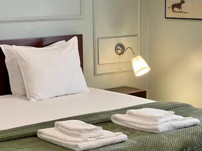 a bed with two towels sitting on top of it at Fly House Faro in Faro