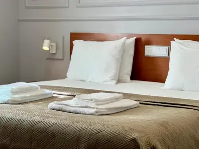 two towels on a bed in a hotel room at Fly House Faro in Faro