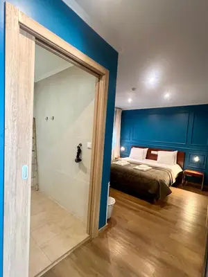 a bedroom with a bed and a bathroom with a shower at Fly House Faro in Faro