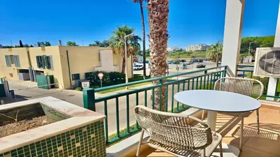 a balcony with a table and chairs and a street at Marina Sol - CD 308, Cleverdetails - great location in Vilamoura