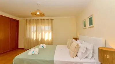 a bedroom with a bed with two slippers on it at Marina Sol - CD 308, Cleverdetails - great location in Vilamoura