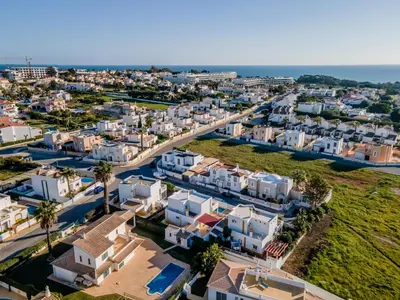an aerial view of a city with houses and the ocean at Pet-Friendly with Private Pool Close to the Beach in Galé