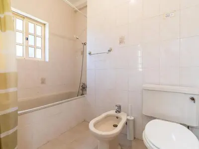 a bathroom with a toilet and a tub and a sink at Villa Paradis Paraiso com piscina privada em Albufeira in Albufeira