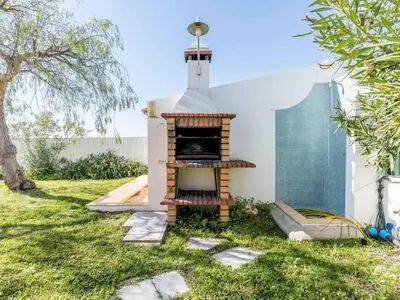 a outdoor pizza oven in a yard at Villa Paradis Paraiso com piscina privada em Albufeira in Albufeira