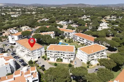 an aerial view of a campus with buildings and a red marker at NEW! Vilamoura Garden View in Quarteira